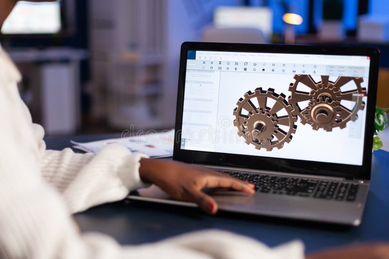 Close up of mechanical gears while engineer working with software stock photo