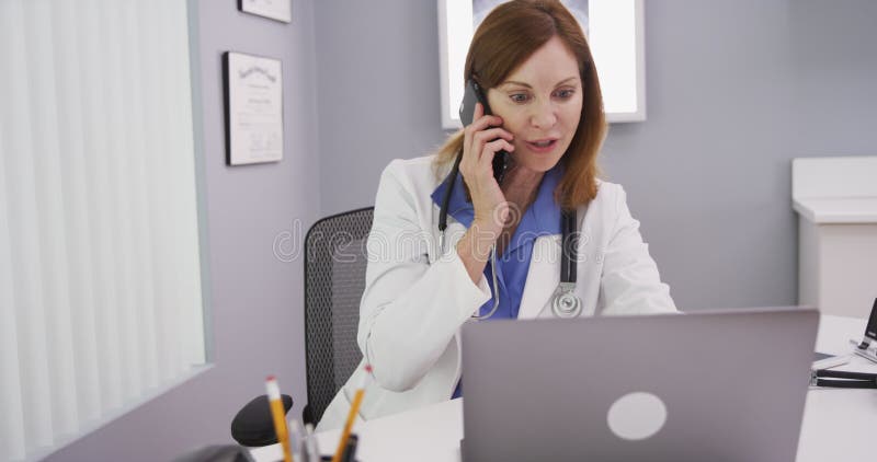 Close up of medical physician discussing with patient on phone her test results