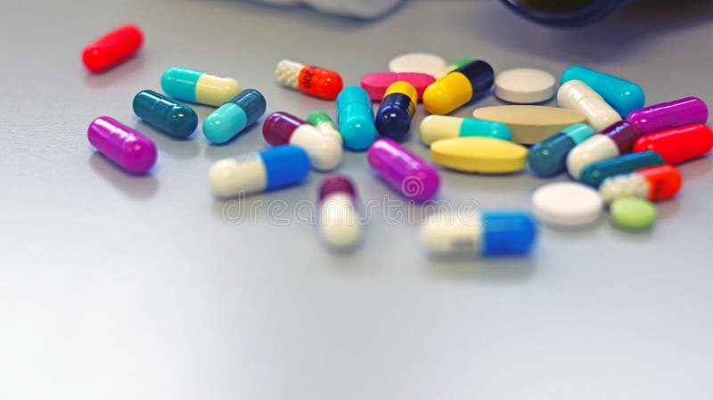 Close up medicine bottles with colorful tablets, pills, capsules drugs using for treatment and cure the disease. White and Brown glass medicine bottles with royalty free stock photo Close up medicine bottles with colorful tablets, pills, capsules drugs using for treatment and cure the disease. White and Brown glass medicine bottles with royalty free stock photo