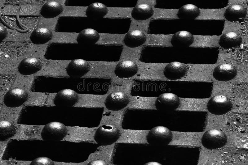 Close Up of Grate Full of Water on the Sidewalk. Stock Image Image of