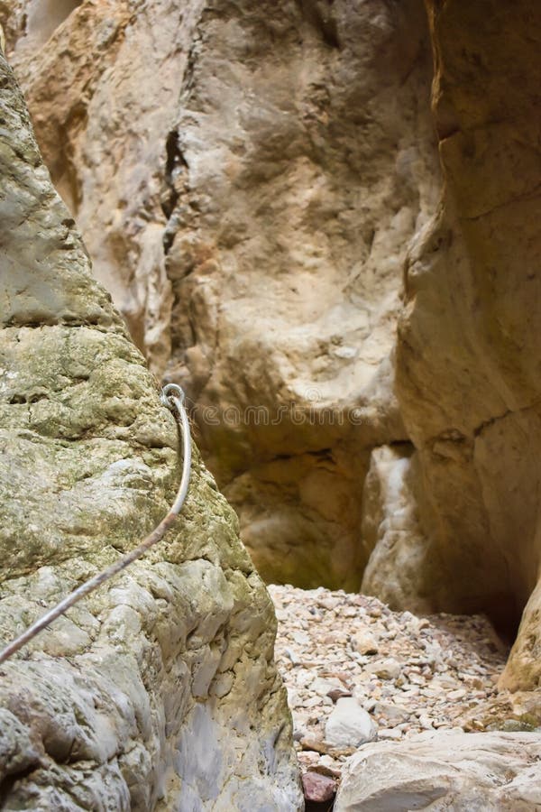 close up of a metallic string to climb a vertical white stone of the wall of a mountain helping to hikers to save the gap to get royalty free stock photo close up of a metallic string to climb a vertical white stone of the wall of a mountain helping to hikers to save the gap to get royalty free stock photo