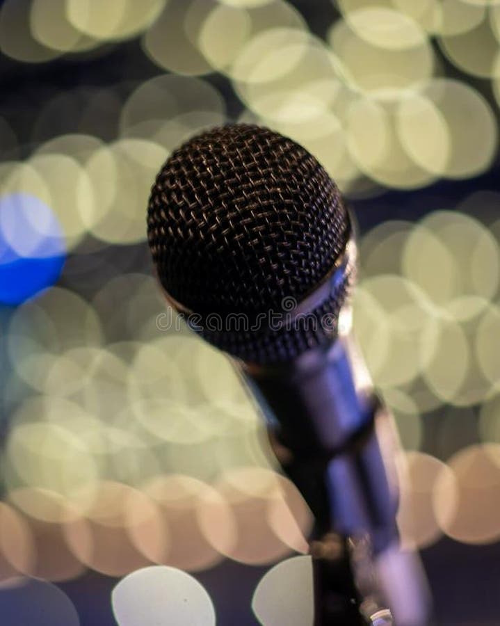 Close-up of a microphone with a colorful bokeh background. royalty free stock photos