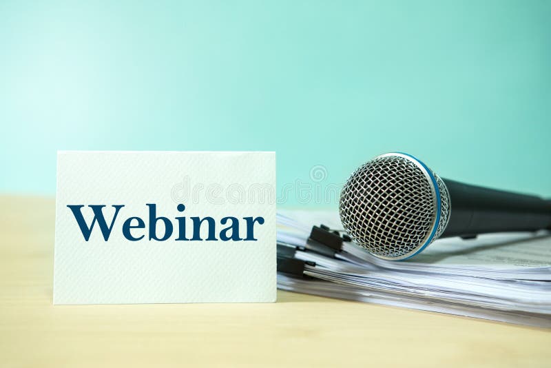 Close up Microphone on a paper document with Webinar text, concept of speaker or teacher preparation to speak in seminar class royalty free stock image