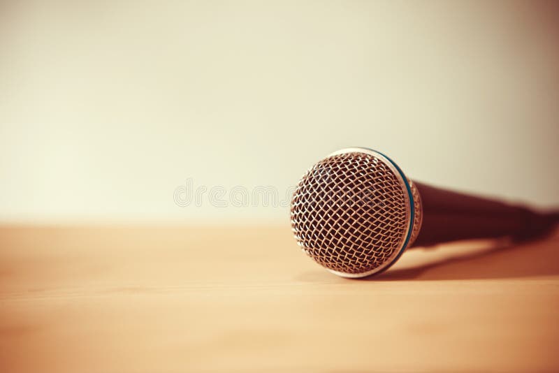 Close up a Microphone on the table, concept of speaker or teacher preparation to speak in seminar class room royalty free stock photo