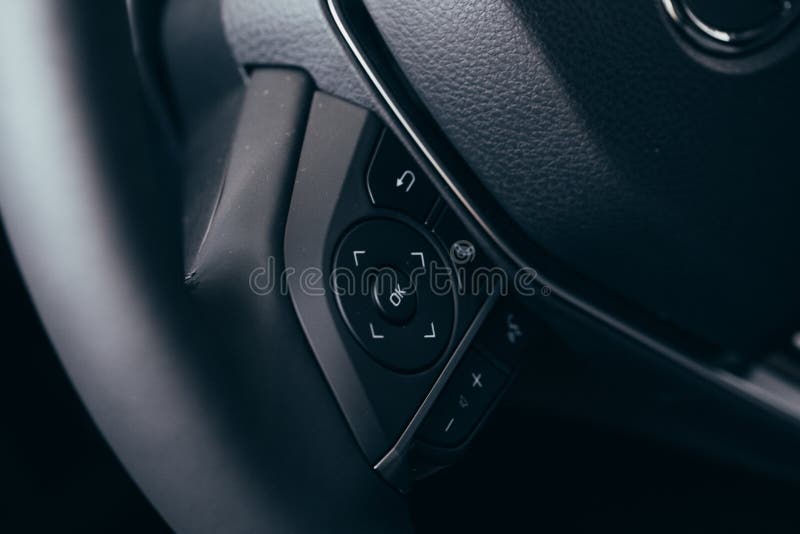 Audio Control Buttons on the Steering Wheel of a Modern Car Stock Photo