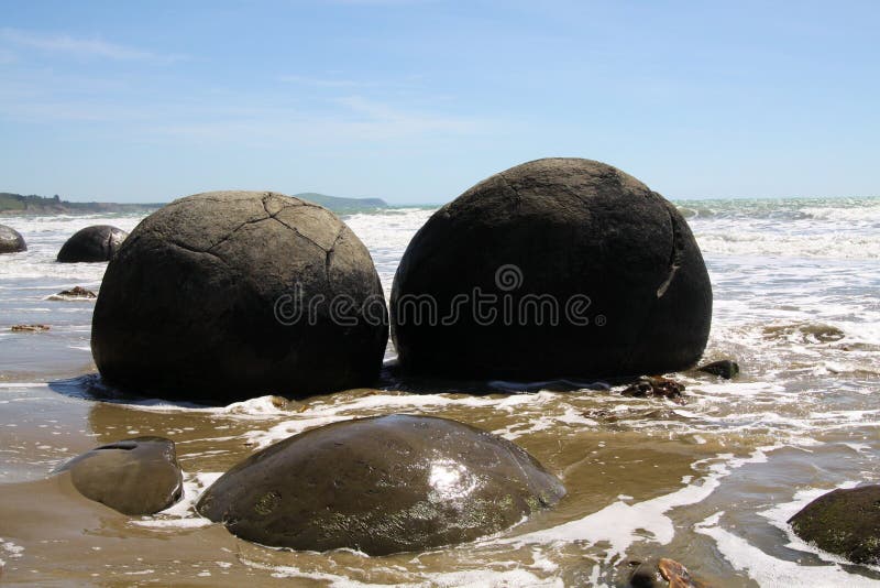Close up of Moeraki spherical boulders of mudstone on the beach washed by surf of the sea, Koekohe Beach, Pebble beach New Zealand royalty free stock photography Close up of Moeraki spherical boulders of mudstone on the beach washed by surf of the sea, Koekohe Beach, Pebble beach New Zealand royalty free stock photography