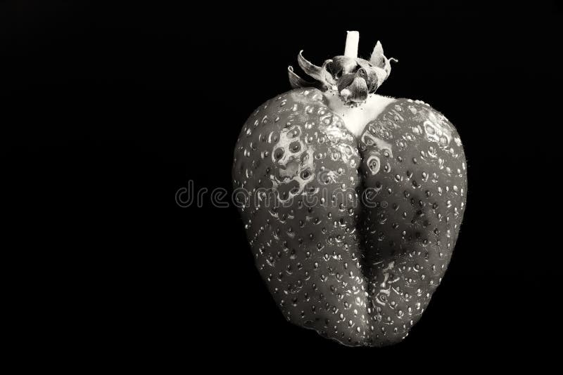 Close up, monochromatic image of an unusual strawberry fruit looking like female butt stock photos Close up, monochromatic image of an unusual strawberry fruit looking like female butt stock photos