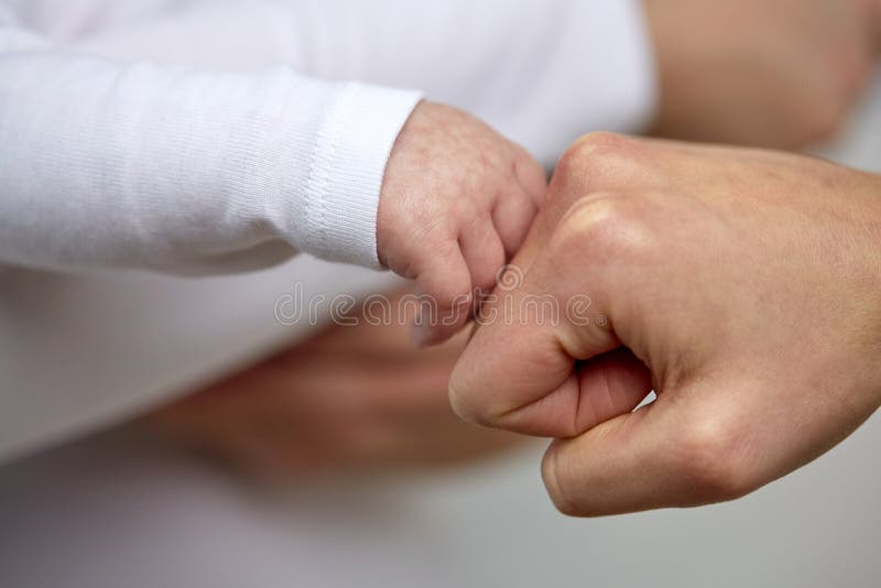 Close up of mother and newborn baby hands