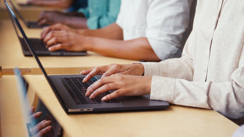 Close Up Of Multi-Cultural Business Team Typing On Laptop Computer Keyboard In Modern Office royalty free stock photos