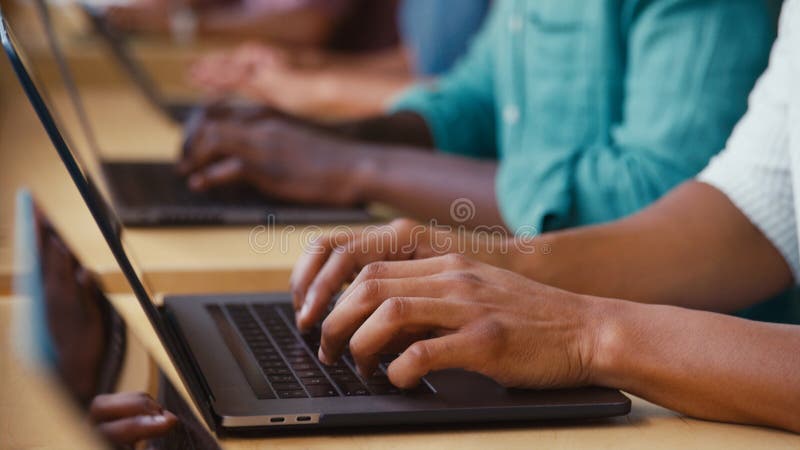 Close Up Of Multi-Cultural Business Team Typing On Laptop Computer Keyboard In Modern Office royalty free stock photography