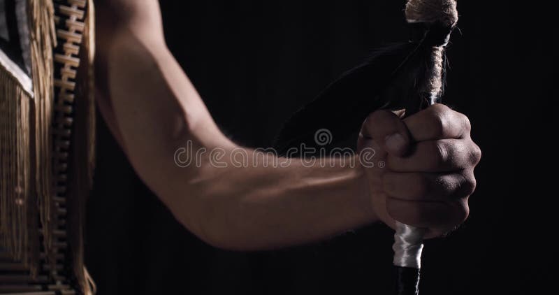 Close up of a muscular hand of a native American man holding a spear, 4k