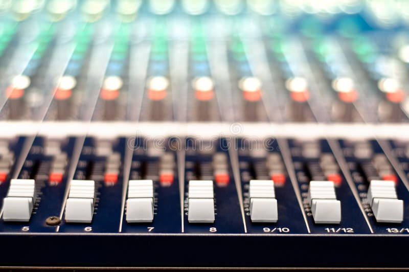 Close-up of music controls buttons of studio mixer. Controlling lights and music with a mixer machine