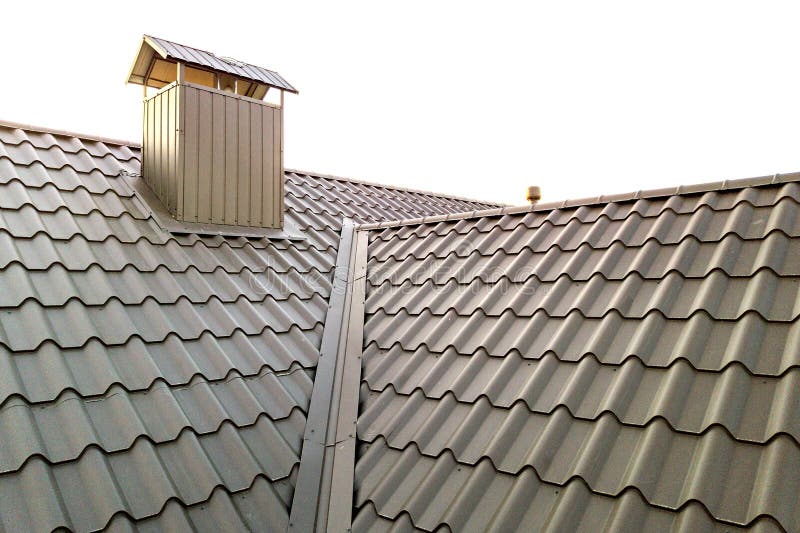 Close up of new house roof structure covered with metal tile sheets.