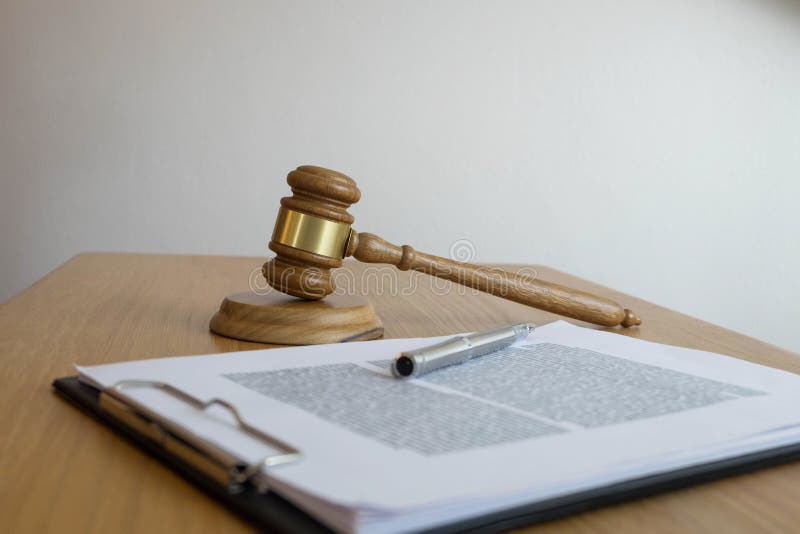 Close up object law concept. Judge gavel with justice lawyers and documents working on table stock photography Close up object law concept. Judge gavel with justice lawyers and documents working on table stock photography