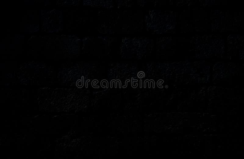 Closeup of an Old, Aged and Dark Gray, almost Black, Brick Wall. Stock
