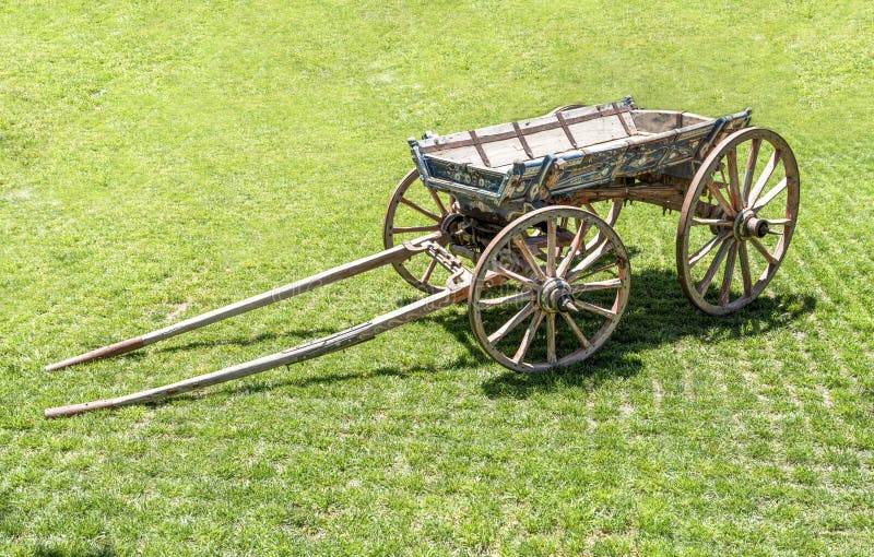Close up on an old antique wagon. Turkish horse drawn vehicle on green grass