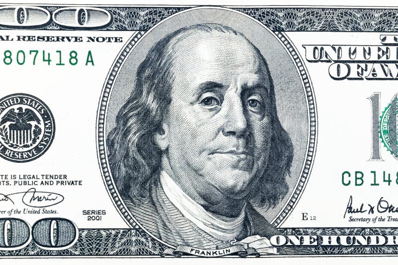 Close up overhead view of Benjamin Franklin face on 100 US dollar bill. US one hundred dollar bill closeup. Heap of one hundred