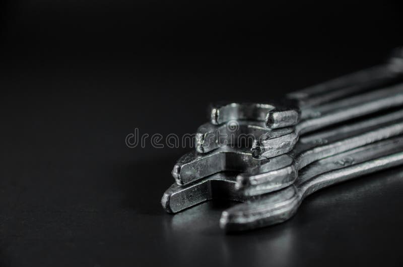 Overlap wrenchs on black background royalty free stock photography