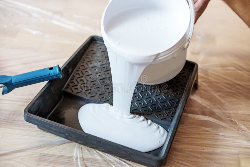 Close Up of Paint Roller in Tray. Closeup View of Paint Tray Filled