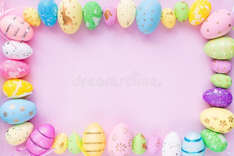 Close-up of painted eggs of different colors on a lilac background. Design for Easter greetings