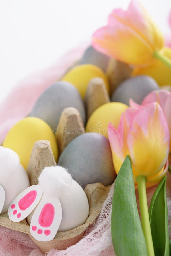 Closeup of Pastel Easter Eggs with Pink Tulips, Easter Bunny on Pink