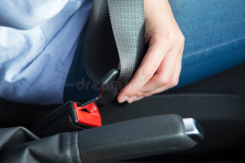 Close Up Of Person In Car Fastening Seat Belt royalty free stock images Close Up Of Person In Car Fastening Seat Belt royalty free stock images