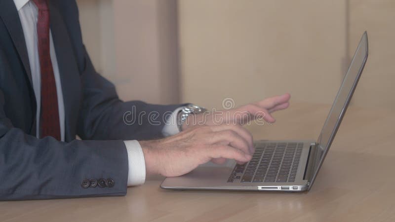 Close up person with necktie working on pc stock photo Close up person with necktie working on pc stock photo