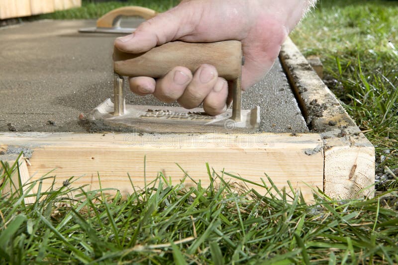 Man Using Edging Tool on Wet Cement Slab Close Up Stock Photo Image