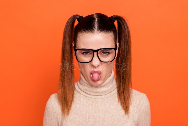 Close up photo disappointed teen teenager specs offended dont want communicate, make faces irritated crazy like child childish playful trendy stylish turtleneck  orange background. Close up photo disappointed teen teenager specs offended dont want communicate, make faces irritated crazy like child childish playful trendy stylish turtleneck  orange background