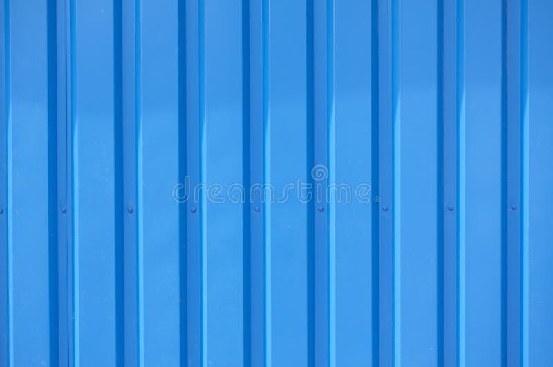 Close up photo of a facade from an industrial building with graphic stripes of minimalistic vertical blue metal profiles. Backgrou stock photo