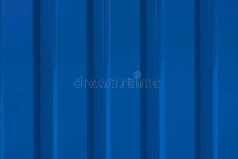 Close up photo of a facade from an industrial building with graphic stripes of minimalistic vertical blue metal profiles. Backgrou royalty free stock photography