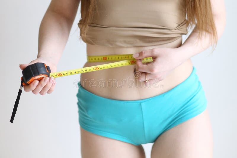 Close Up Photo of Model Girl Measure Her Waist with Measuring Tape in Blue  Pants Close Up Photo Stock Image - Image of health, fasting: 169212791