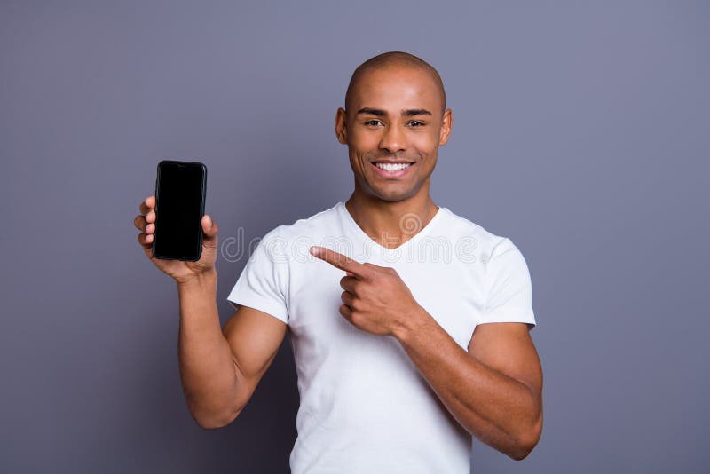 Close up photo strong healthy dark skin he him his macho bald head finger show new telephone version advising buy buyer promotional wearing white t-shirt outfit clothes isolated grey background.
