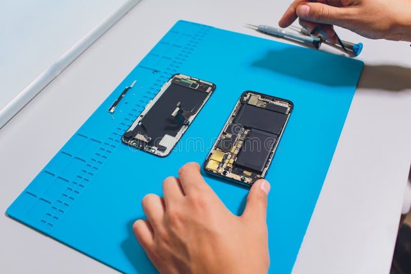 Closeup Photos Showing Process of Mobile Phone Repair. Stock Photo