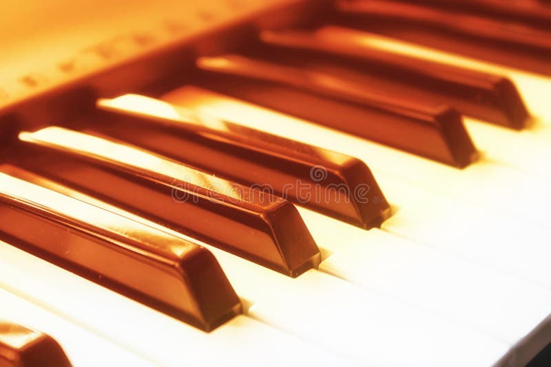 Close-up of piano keys and light dust, solar tinted, front view. Music and romance