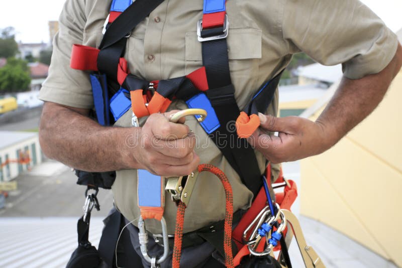 Close up pic of male industrial rope access worker wearing fall arrest, fall restraint safety protection harness royalty free stock photos Close up pic of male industrial rope access worker wearing fall arrest, fall restraint safety protection harness royalty free stock photos