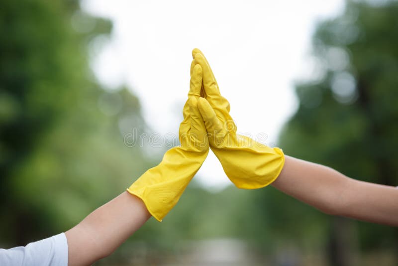 Children`s Hands in Blue Latex Gloves Holding Plastic Bottles on a Park ...