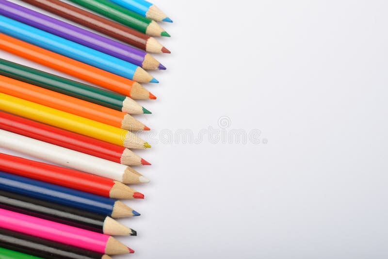 Close up picture of many little colored pencil crayons on white. Background. Assortment of sharpened colored pencils/ Colored drawing pencils. Selective focus stock photography Close up picture of many little colored pencil crayons on white. Background. Assortment of sharpened colored pencils/ Colored drawing pencils. Selective focus stock photography
