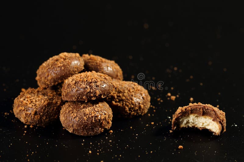 Close up of a pile and half bitten delicious crunchy caramel biscuits coated with milk chocolate and biscuit particles royalty free stock image Close up of a pile and half bitten delicious crunchy caramel biscuits coated with milk chocolate and biscuit particles royalty free stock image