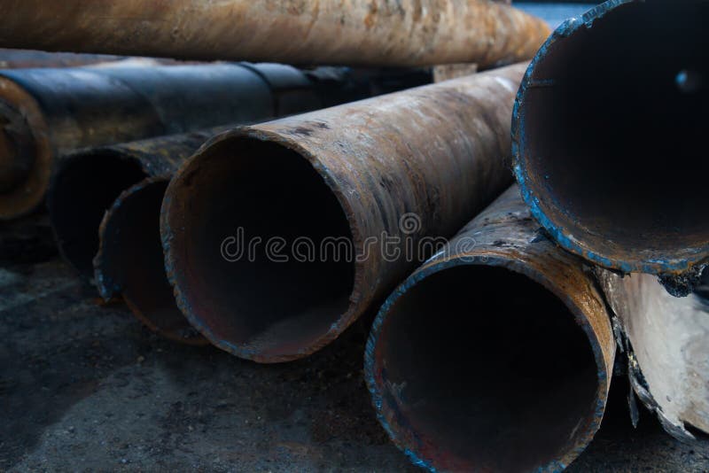 Close up of a pile of large and rusting steel pipes lying royalty free stock images Close up of a pile of large and rusting steel pipes lying royalty free stock images
