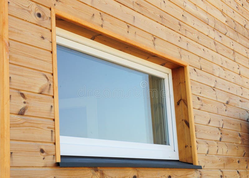 Close up on Plastic PVC Window in New Modern Passive Wooden House Facade Wall.