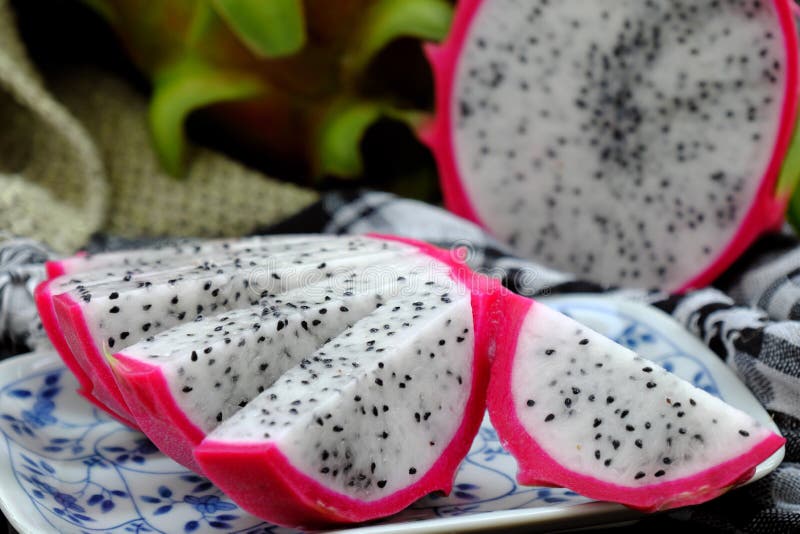Dragon fruits cut in sliced, tropical Vietnamese fruit, pink peel, white flesh, small seeds royalty free stock photo Dragon fruits cut in sliced, tropical Vietnamese fruit, pink peel, white flesh, small seeds royalty free stock photo