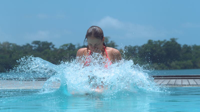 Close Up Girl Pinches Her Nose And Jumps Into Beautiful Crystal Clear