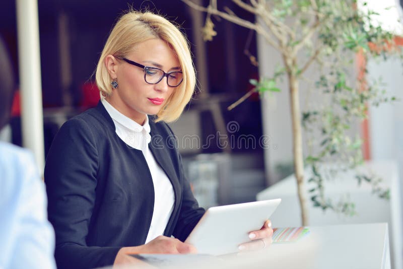 Close-up portrait of active business woman holding laptop while standing at office. royalty free stock photos Close-up portrait of active business woman holding laptop while standing at office. royalty free stock photos