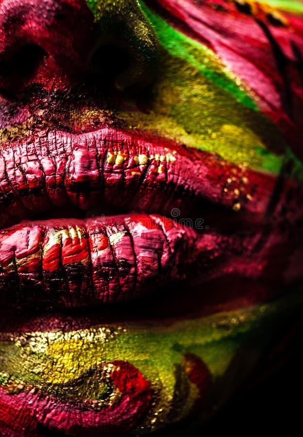 Close-up portrait of an artistic woman painted with red & green color. Part of face photo stock photography