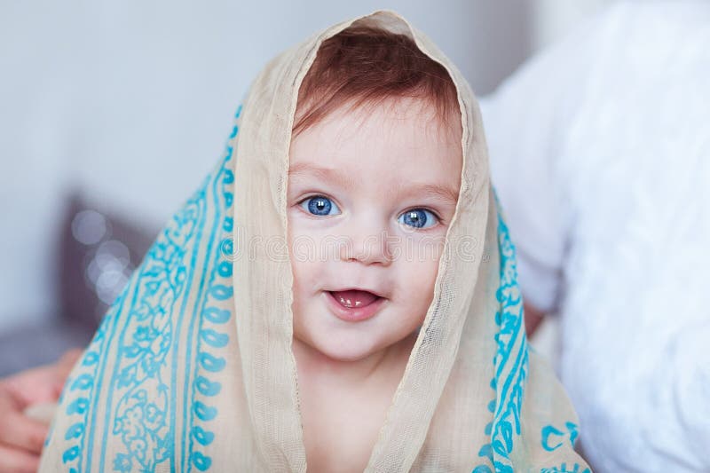 Close Up Portrait of Baby Boy, Head Covered with Shawl Stock Image