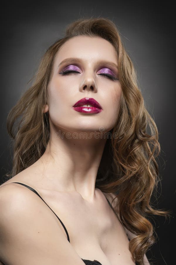 Close up portrait of a beautiful blonde girl model. Red lips and pink make up. Healthy clear skin