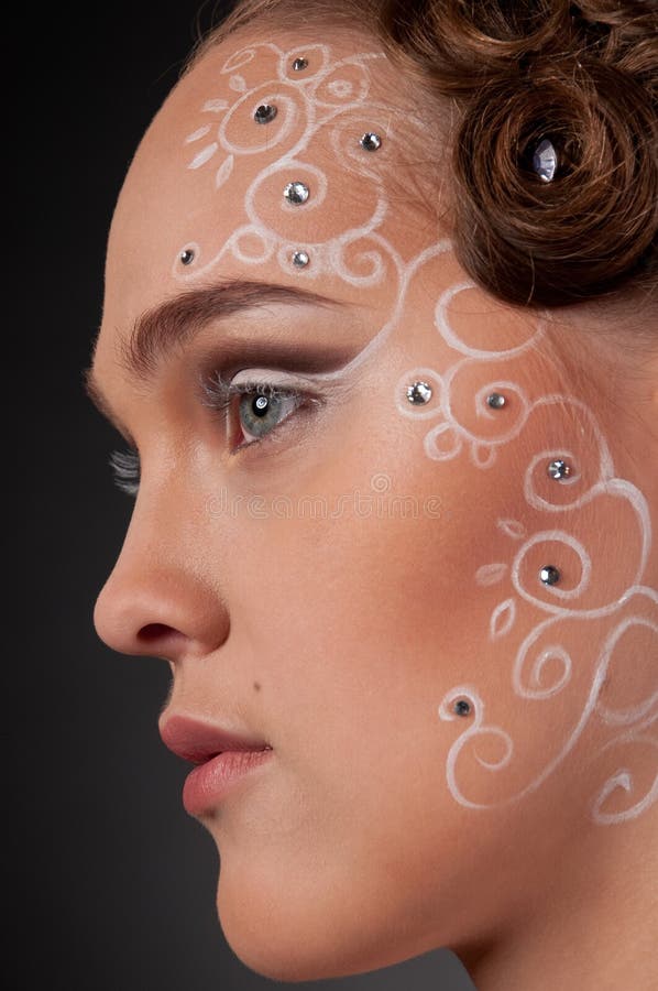 Close up portrait of beautiful girl with face art