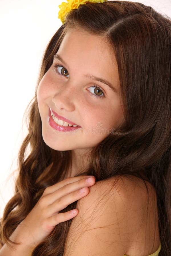 Close-up portrait of a beautiful happy brunette child girl with chic long hair