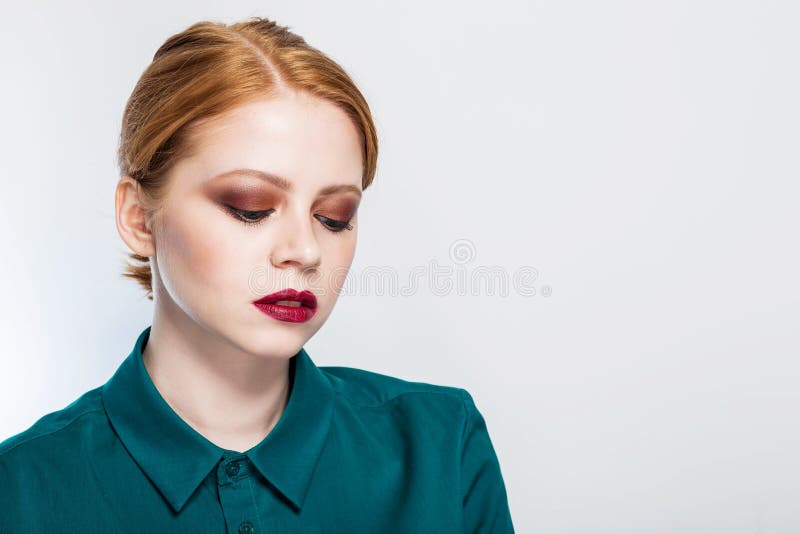 Close-up portrait of a beautiful red haired girl with bright makeup. Beauty, facial care, fashion, clean skin concept royalty free stock image Close-up portrait of a beautiful red haired girl with bright makeup. Beauty, facial care, fashion, clean skin concept royalty free stock image